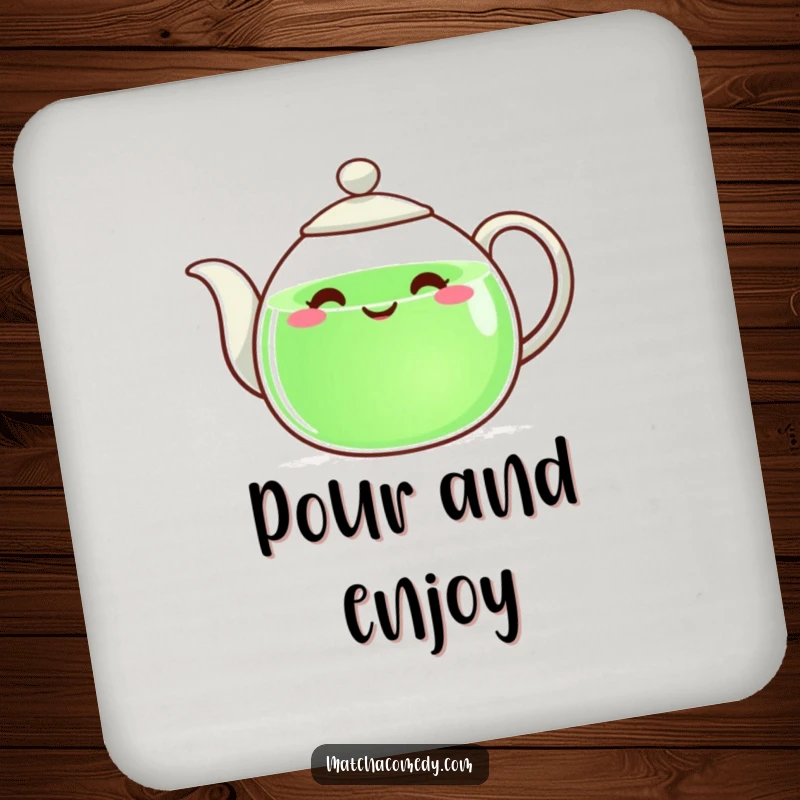 Funny teapot with a happy face pouring green liquid, serving as a functional and humorous drink coaster.
