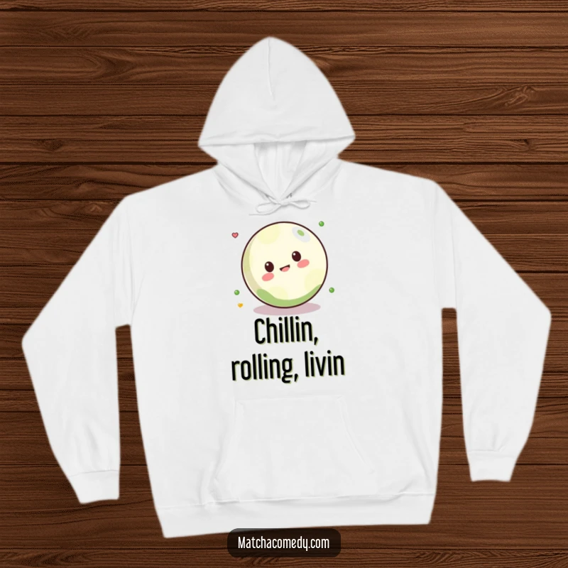 Funny Kawaii matcha ball playfully rolling, depicted on a soft and cozy hoodie for ultimate comfort and humor.