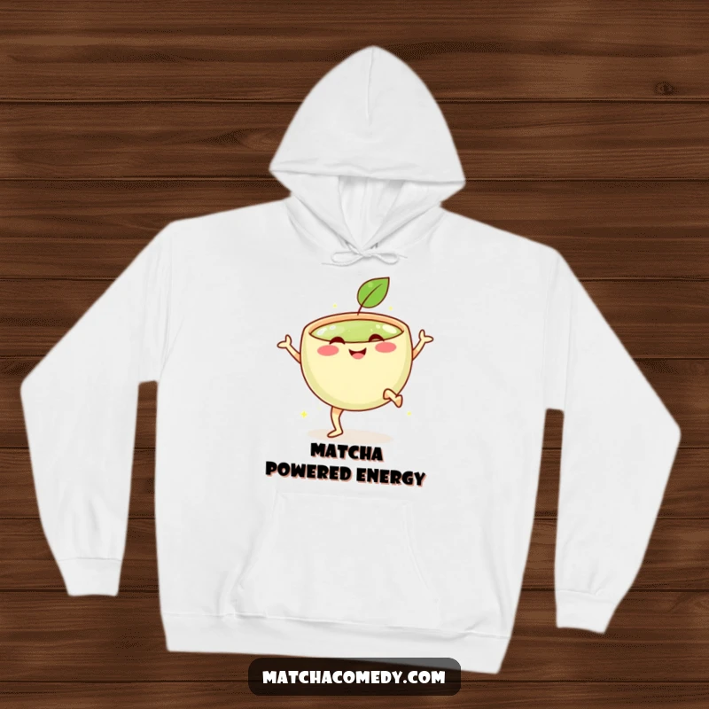 Funny hoodie featuring a smiling matcha bowl with tiny legs, captured in the motion of a vigorous celebratory kick.