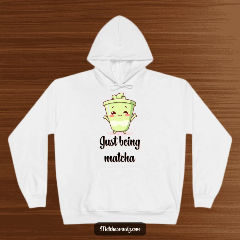 Funny matcha cup hoodie striking a funny pose, cozy apparel for those who love playful silliness.