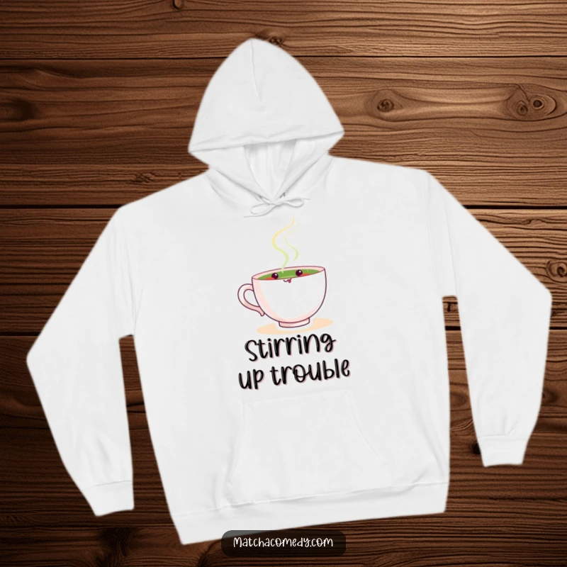 Funny matcha tea cup character calmly stirring, radiating peace and gentle humor on this comfortable and warm hoodie.